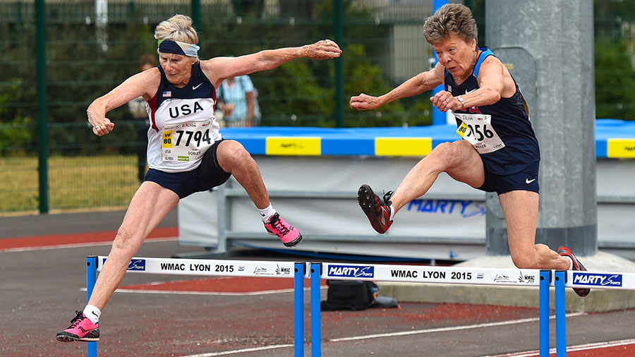 Christel Donley (left) and Flo Meiler battle in hep 80 hurdles, which Christel won (despite fall).