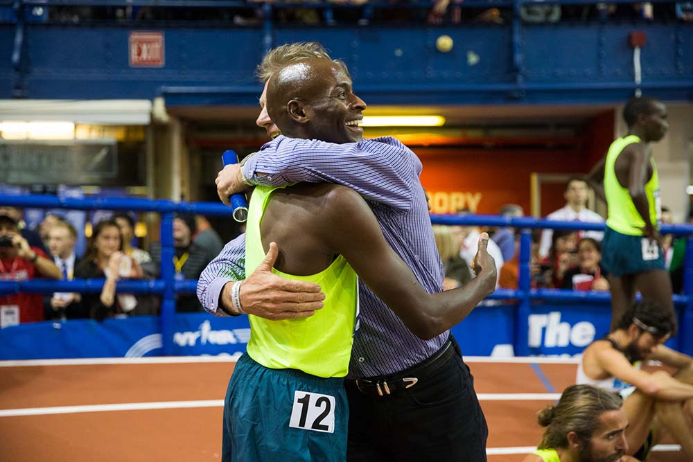 Bernard Lagat gets hug from previous masters mile indoor WR man Eamonn Coghlan at 2015 Millrose.
