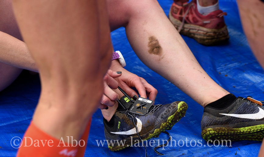 After a women's race, legs and shoes show wear and tear.