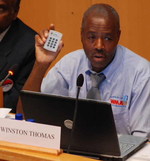 WMA Secretary Winston Thomas shows voting device at Lahti elections.